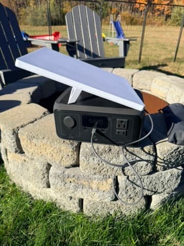 A portable power station powering a Starlink terminal outdoors